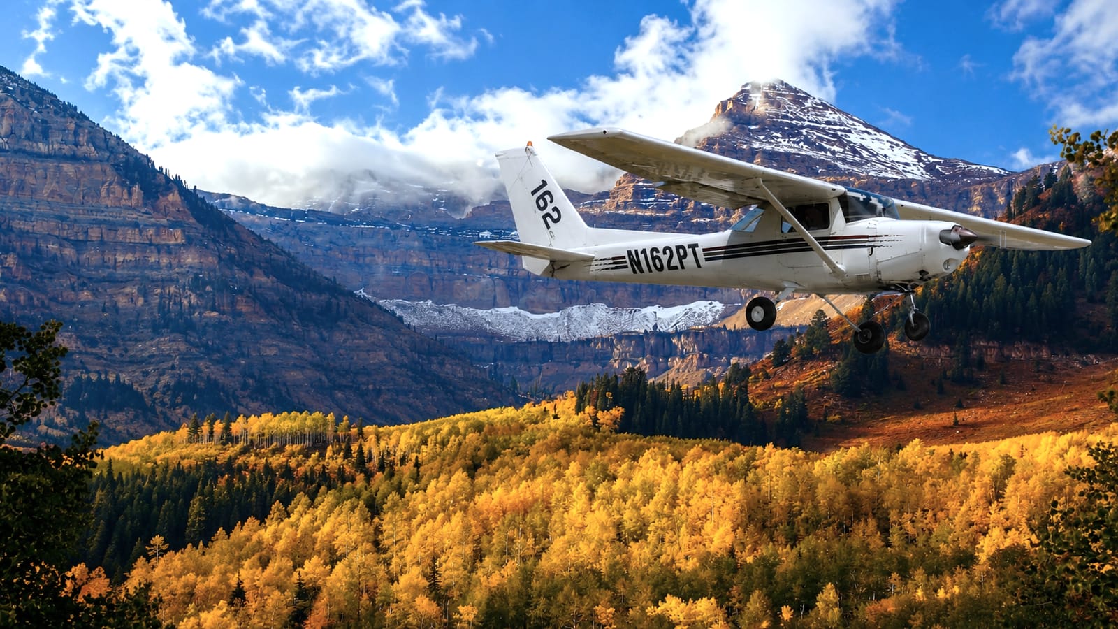 A Cessna flying over the autumn Wasatch mountains in Utah